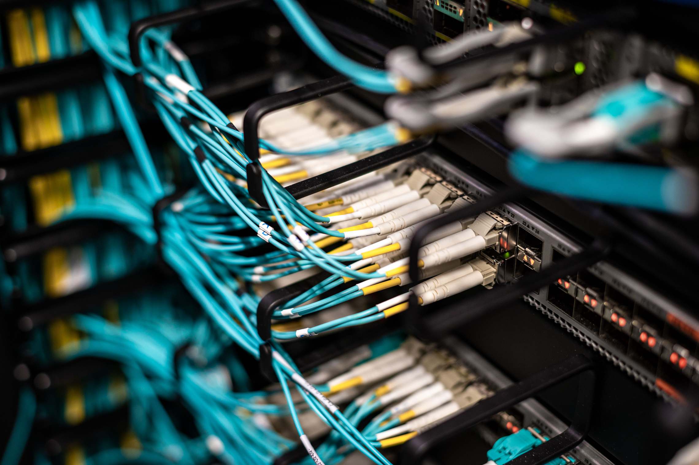 Server racks and network cabling in a data facility with patch panel wires