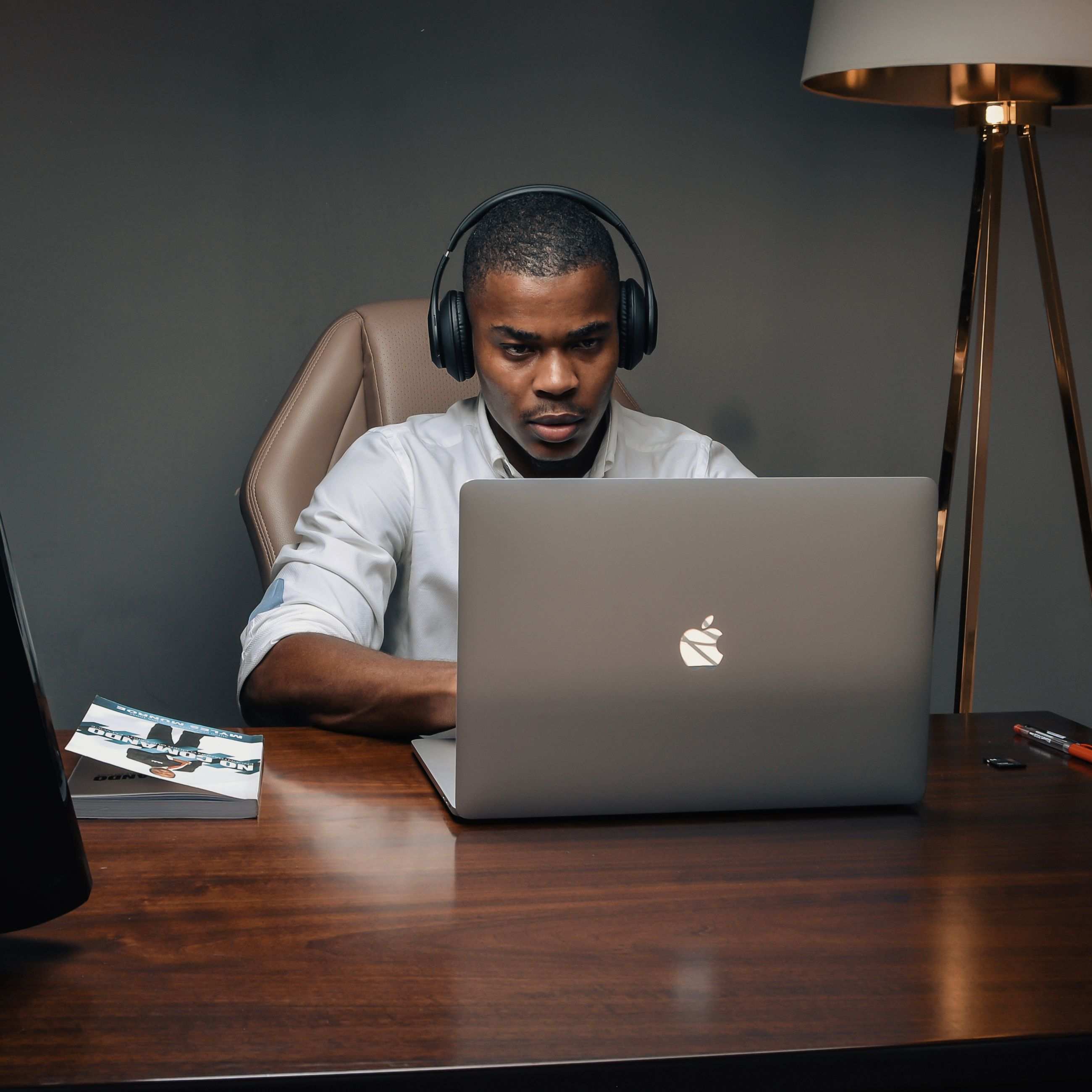 Office workspace with professional working on a laptop